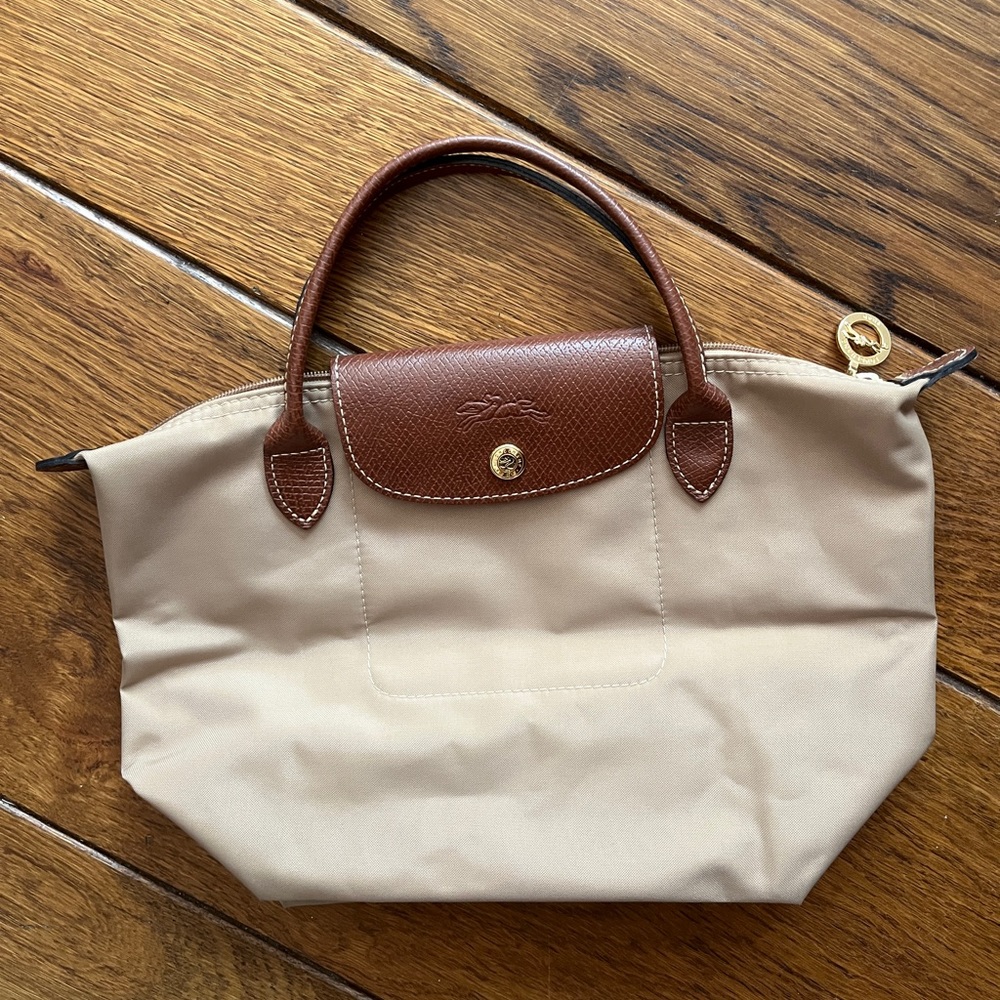 Mini tan Longchamp bag.